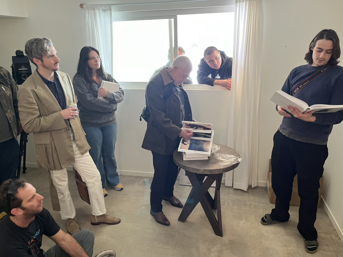 Jacob Messex flips through his new book Euthanasia in a small room in the W(AN)T Studios House at the High Desert Art Fair