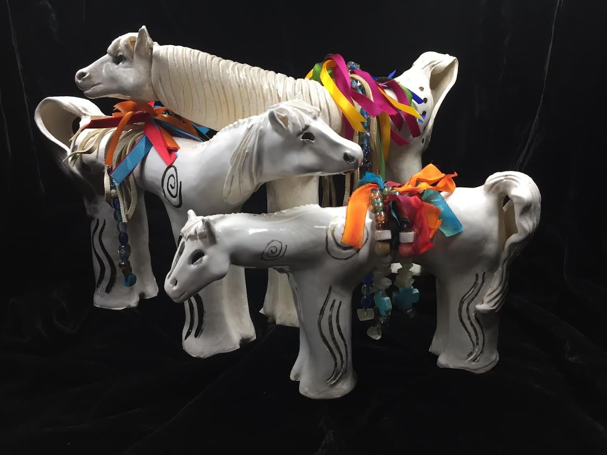 Carol Lujan Taos Spirit Horses, glazed clay figures embellished with colorful ribbons and beads.