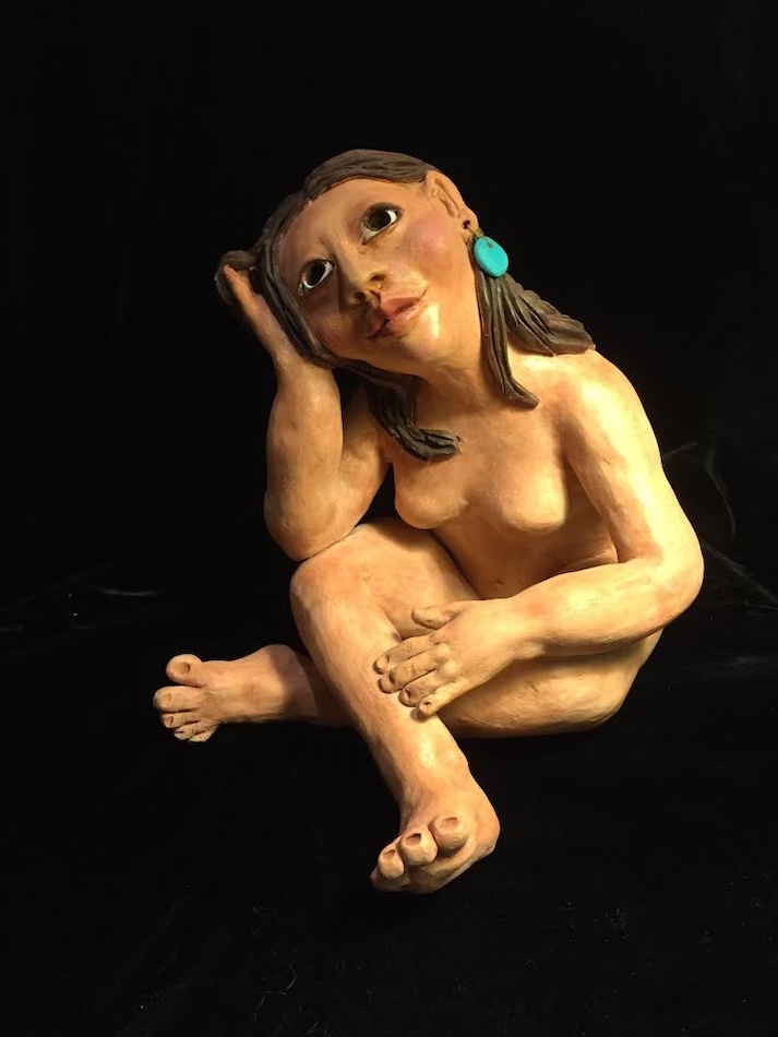 Clay figuring of a nude native woman wearing turquoise earrings, titled Contemplation, by Carol Lujan.