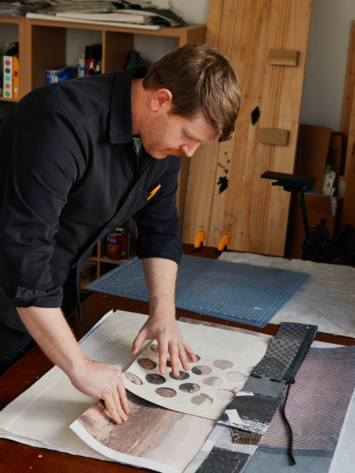 Nick Larsen handles artworks in his studio