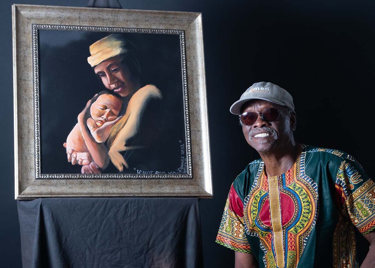 Artist Leonard Wilson with one of his paintings.