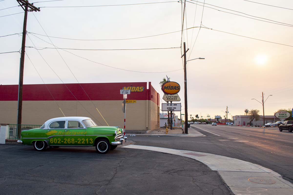 Photo of an intersection in South Phoenix with a bright green car.