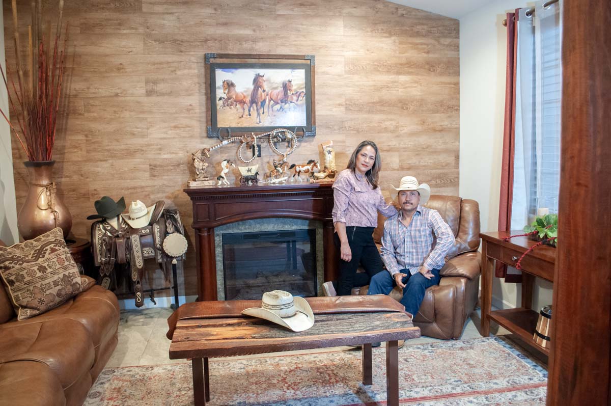 Photo of a couple in their home, with cowboy decor.