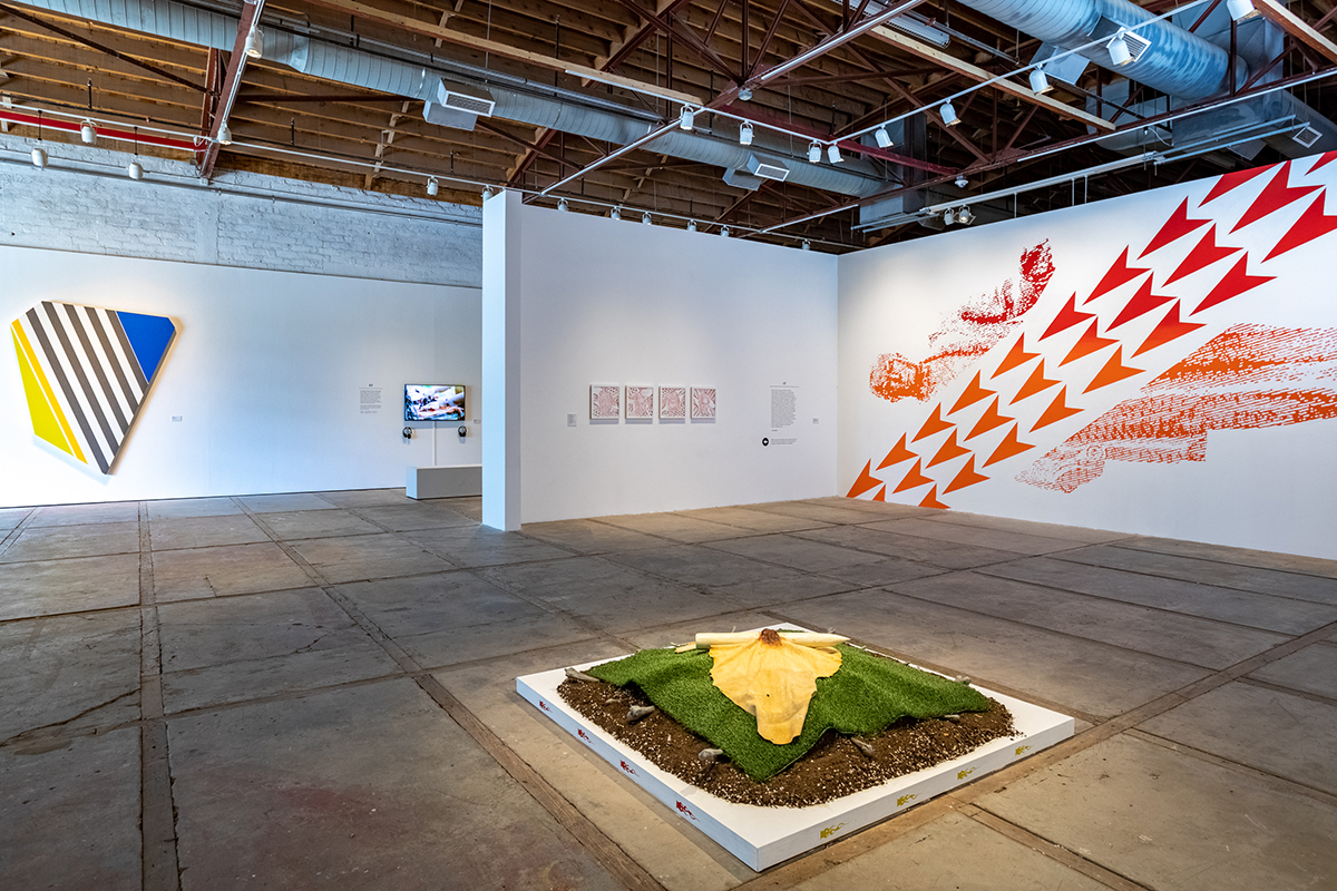 An installation view of a white cube art museum featuring multimedia, large-scale works by Indigenous artists.