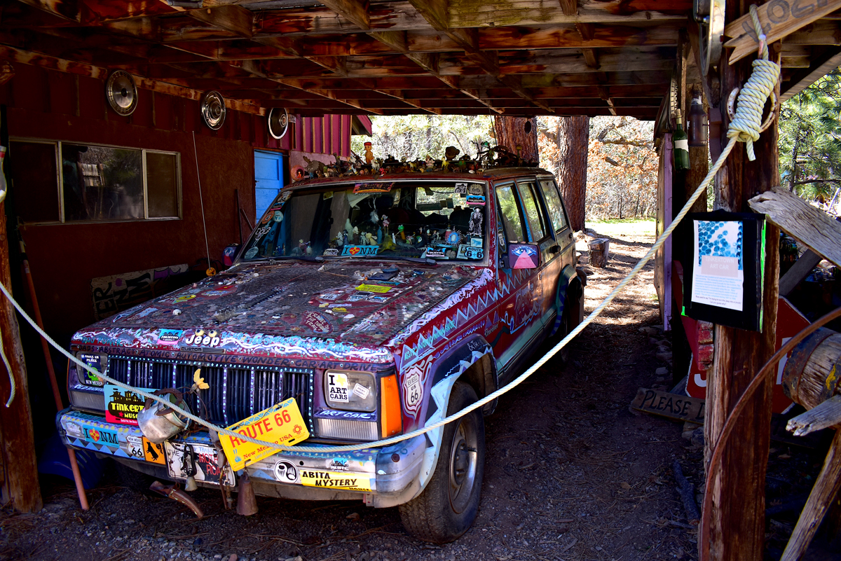 The Tinkertown Museum is one of New Mexico's most famous roadside attractions. This image shows a purple and blue car adorned with intricate patterns and topped with toys.
