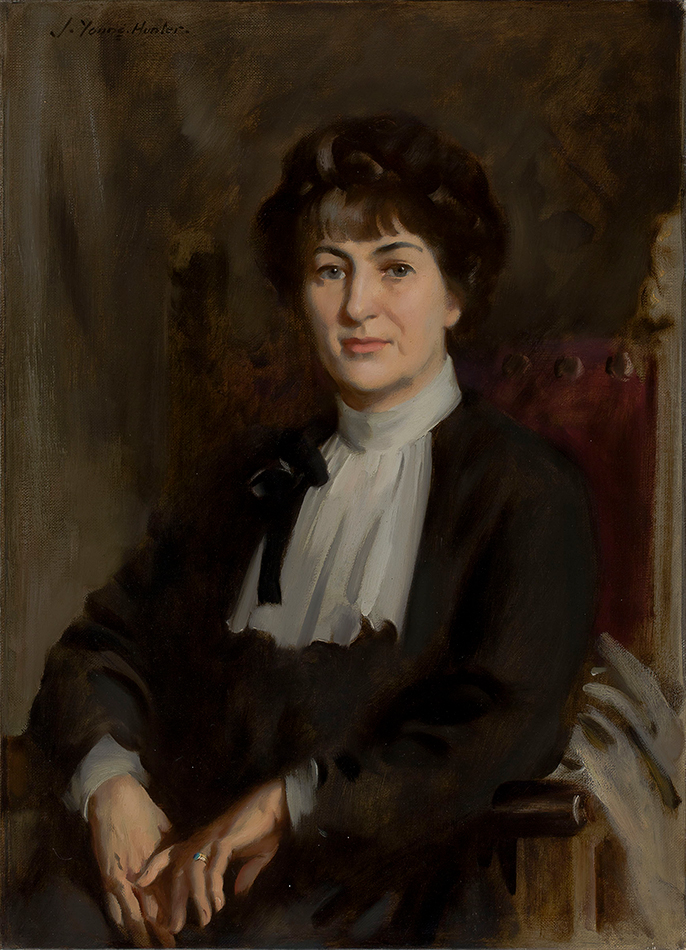 Half-length portrait of Taos art patron Mabel Dodge Luhan with her signature bob and in an austere, black-and-white outfit.