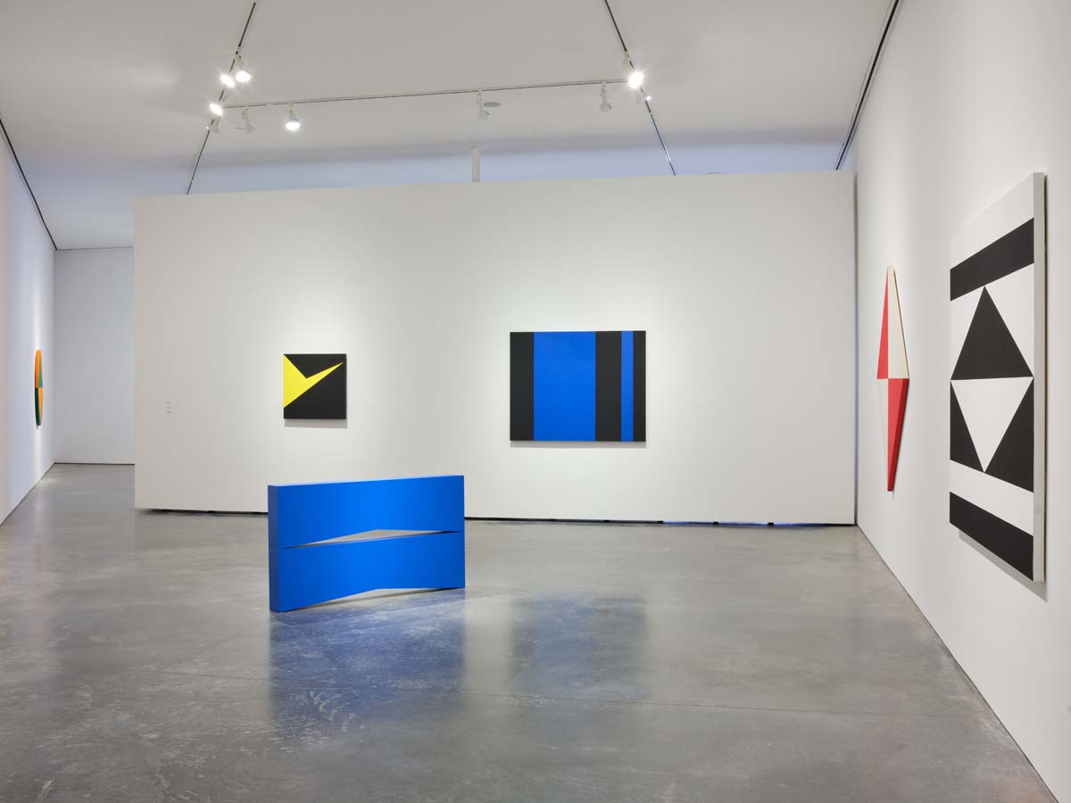 Carmen Herrera at SITE Santa Fe, with a blue sculpture on the floor and geometric canvases on the walls.