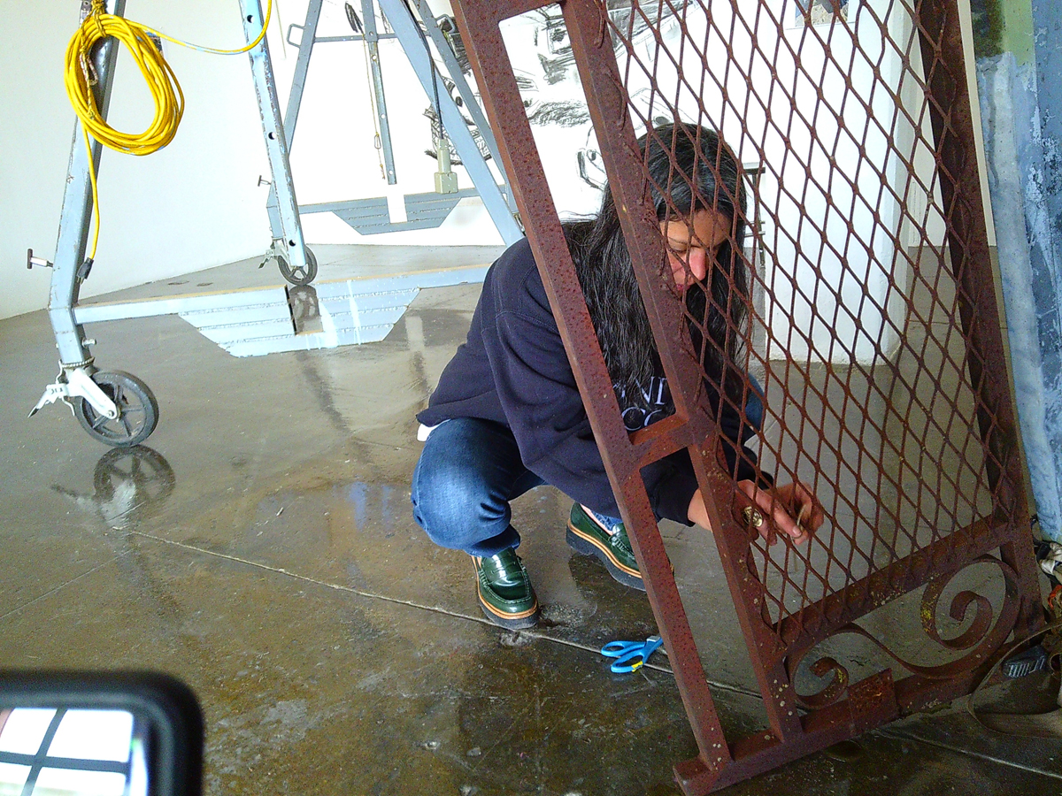 Photograph of Melissa Joseph working on her large-scale installation artwork Texas Jali at the Artpace residency in San Antonio, Texas.