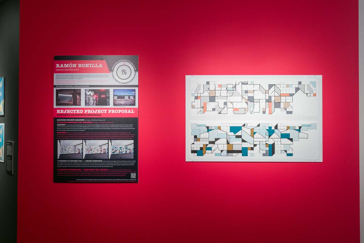 Rejected proposal and artist renderings by Ramón Bonilla on a red wall.