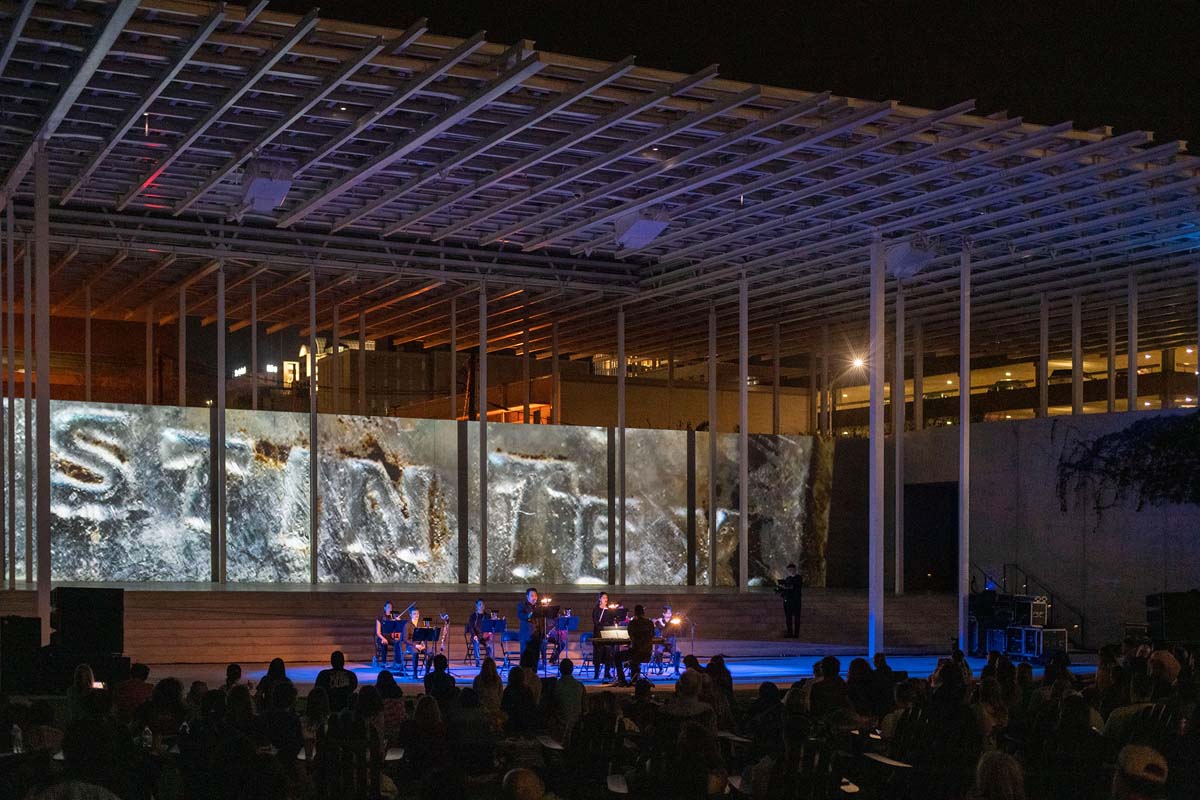 Musical ensemble playing in front of Teresa Hubbard and Alexander Birchler's Past Deposits from a Future Yet to Come on opening night.