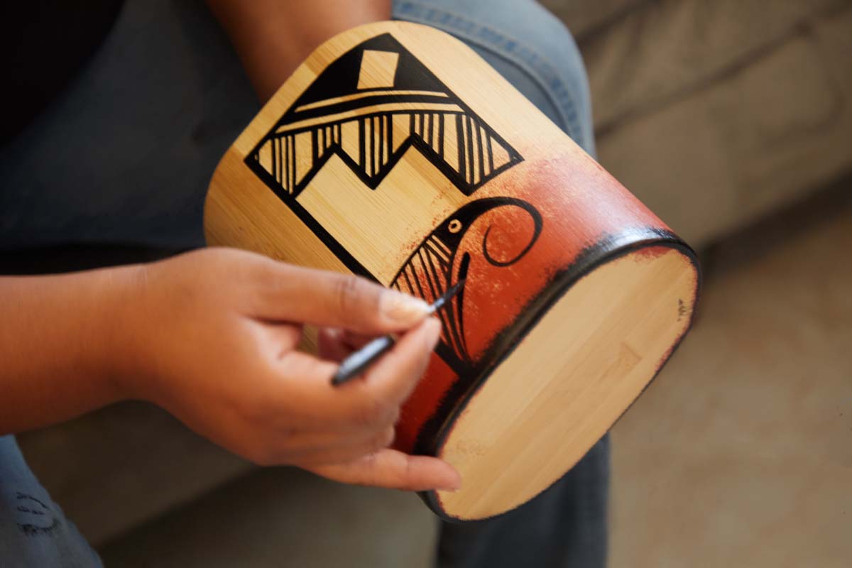 Zuni artist Mallery Quetawki detailing an artwork in her studio.