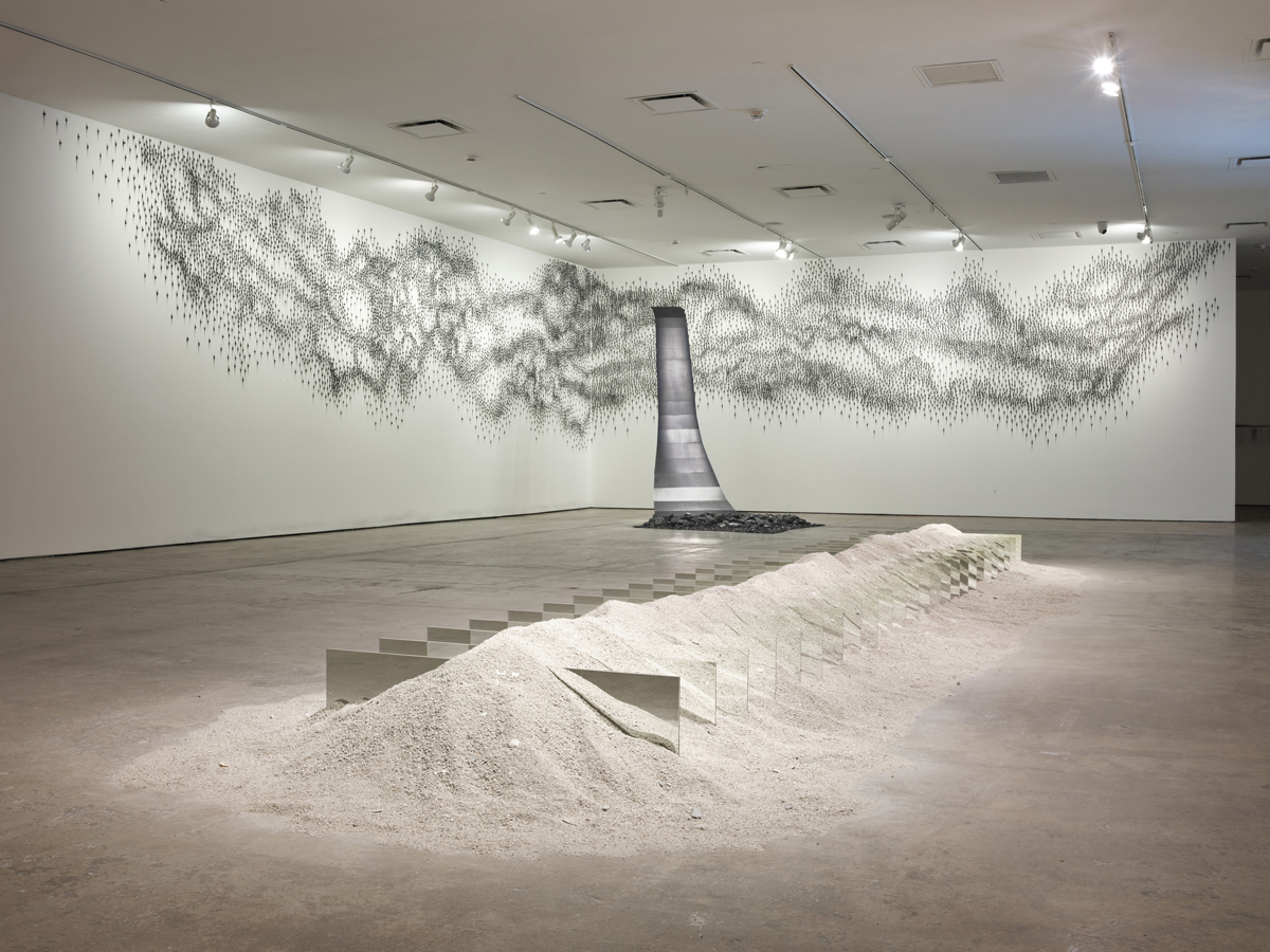 Artworks by Teresita Fernández Robert Smithson at SITE Santa Fe in New Mexico, including a floor piece made from mirrors and sand, and an immersive installation made with shimmering graphite.