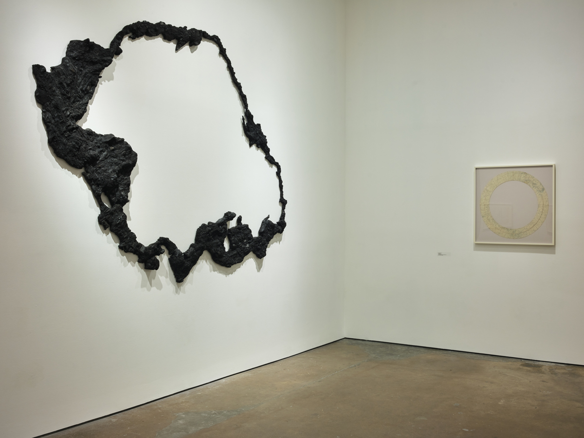 Artworks at SITE Santa Fe in New Mexico, including works made with charcoal and chopped-up maps.