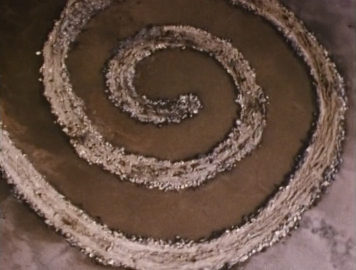 Still from Robert Smithson's Spiral Jetty film, one of the most iconic artworks of the 20th century.