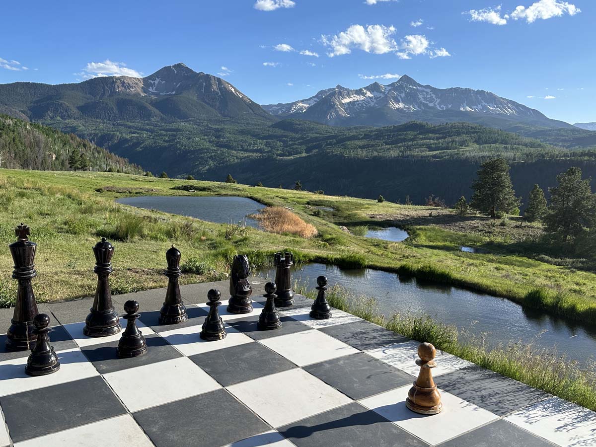 An oversized chess set situated in the Colorado Mountains.