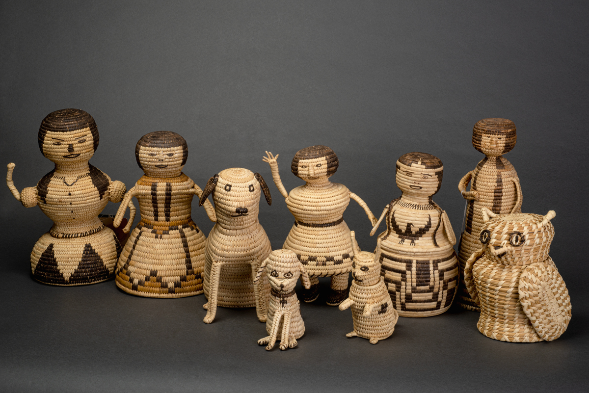 A group of figurative sculptures made with Indigenous basketry techniques. This image is featured in Woven from the Center, a new book on Native basketry by Diane Dittemore.