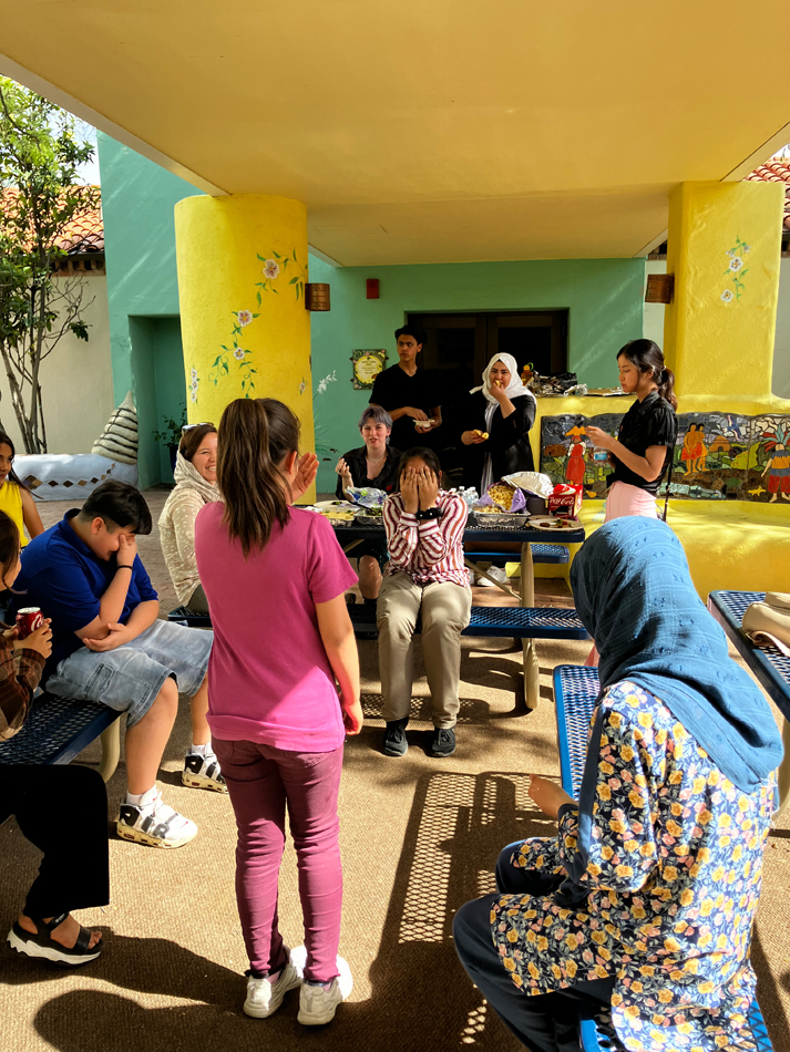 A group of refugee children playing a game at the Tucson Museum of Art courtyard.