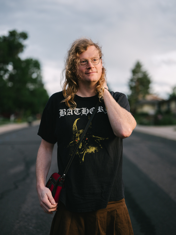 A person poses on the streets of suburban Colorado.