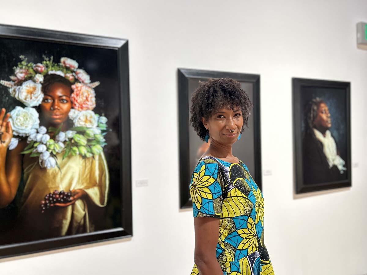 Alanna Airitam with her work in Reclaiming Hope: Afrofuturist Visions at The Gallery at Tempe Center for the Arts