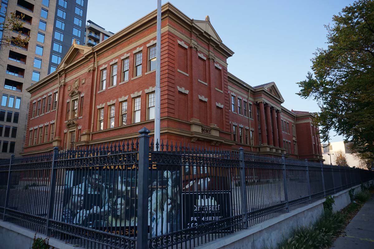 Evans School exterior, with sign by City Street Investors advertising available retail space.