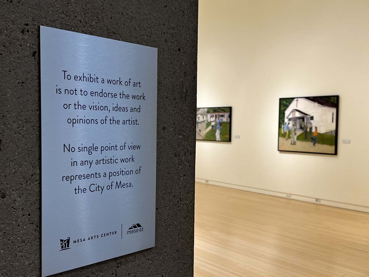 Signage inside Mesa Contemporary Arts Museum (pictured with a previous exhibition featuring art by Jacqueline Chanda). 