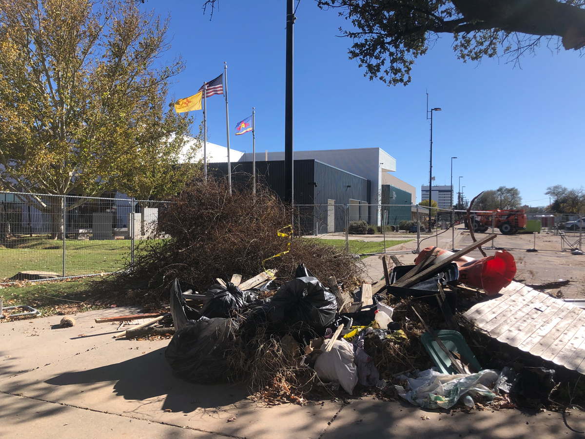 The exterior of Roswell Museum, with debris piled high. View imagery and read stories from the Roswell Museum flood.