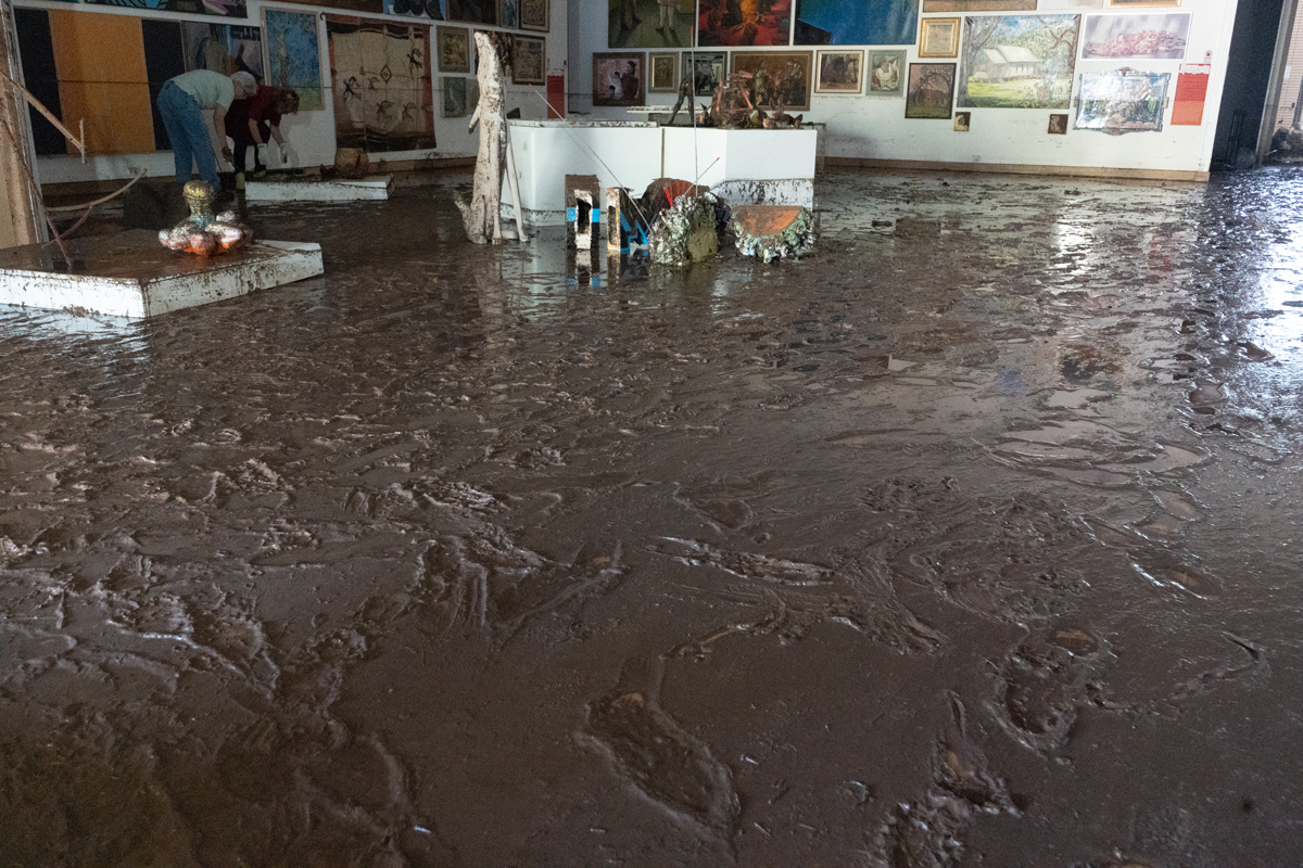 Muddy footprints in a gallery at Roswell Museum. View imagery and read stories from the Roswell Museum flood.