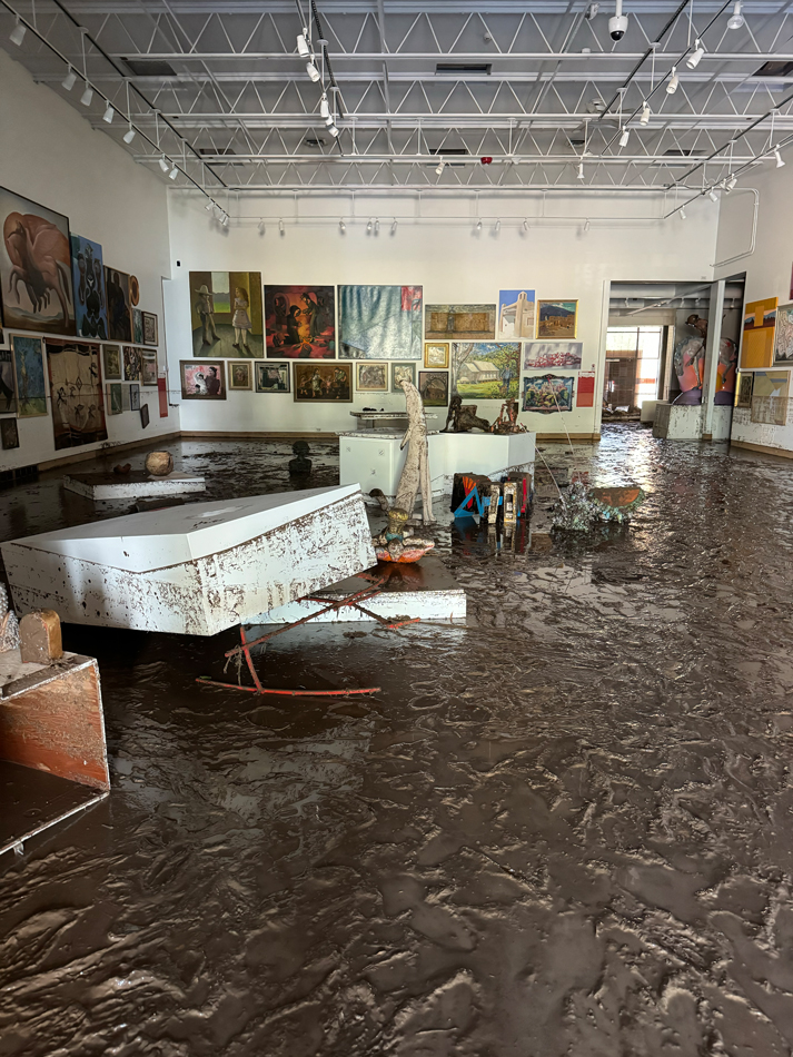 Mud covers the floor of Roswell Museum. View imagery and read stories from the Roswell Museum flood.