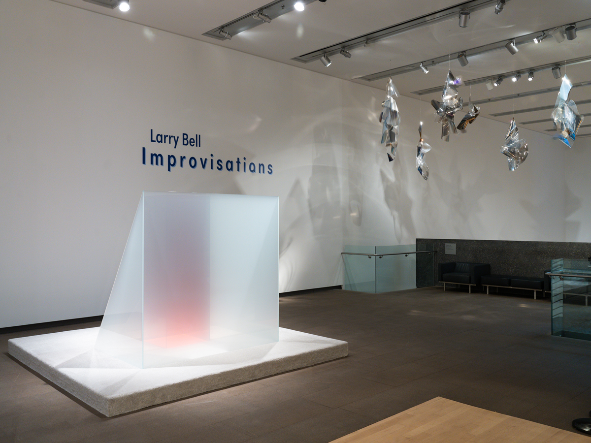 Installation view of a career retrospective by Larry Bell in Phoenix, featuring a large-scale glass sculpture.