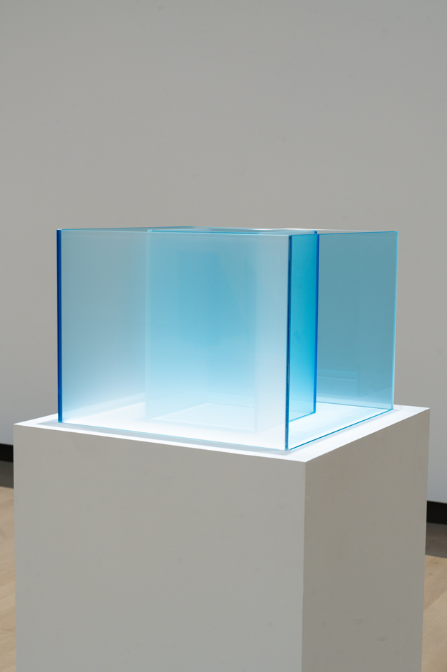 Laminated glass sculptural form in shimmering blue by Larry Bell.