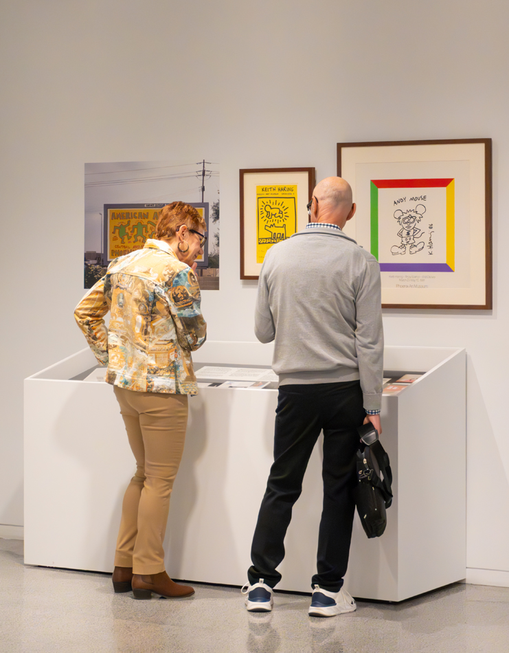 Phoenix Art Museum visitors viewing colorful artworks in The Collection: Keith Haring.