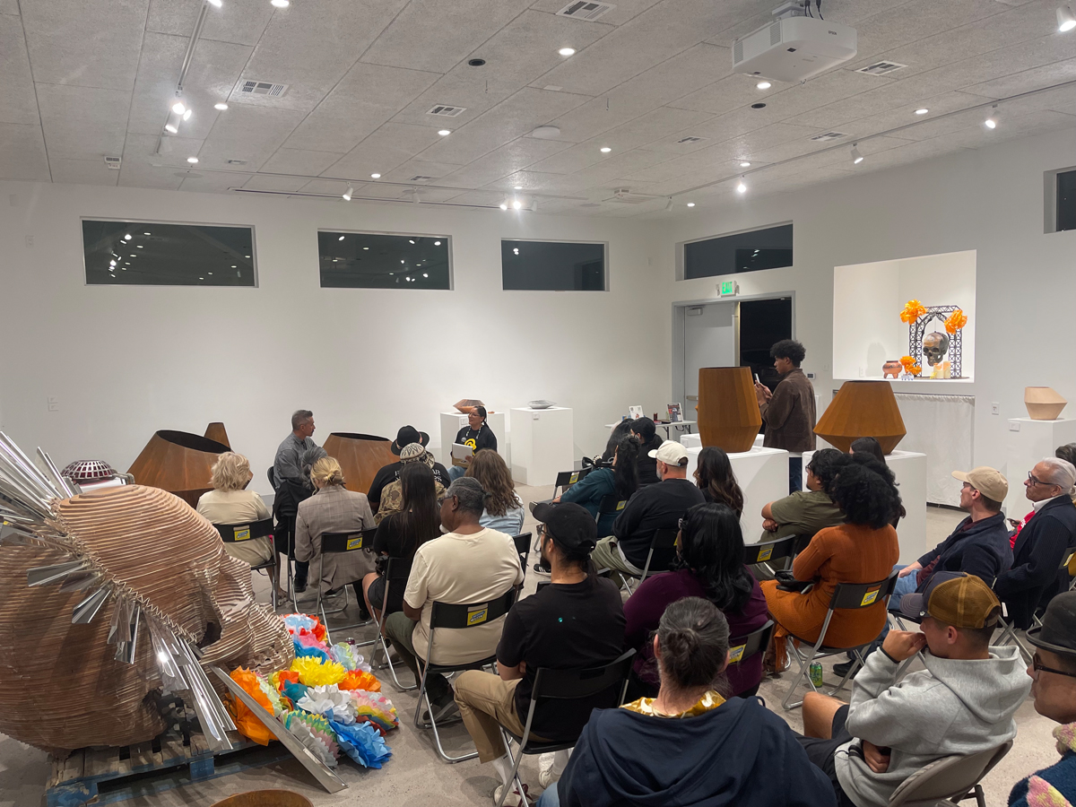 A crowd gathered at Nuwu Art to listen to a conversation between curator Fawn Douglas and artist Luis Varela-Rico.