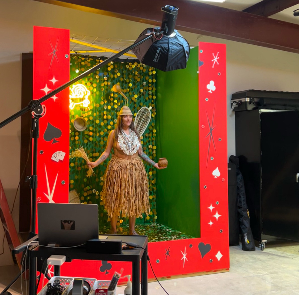 View of Cara Romero's elaborate studio photography process. Fawn Douglas poses inside a colorful set filled with signifiers of Native culture.