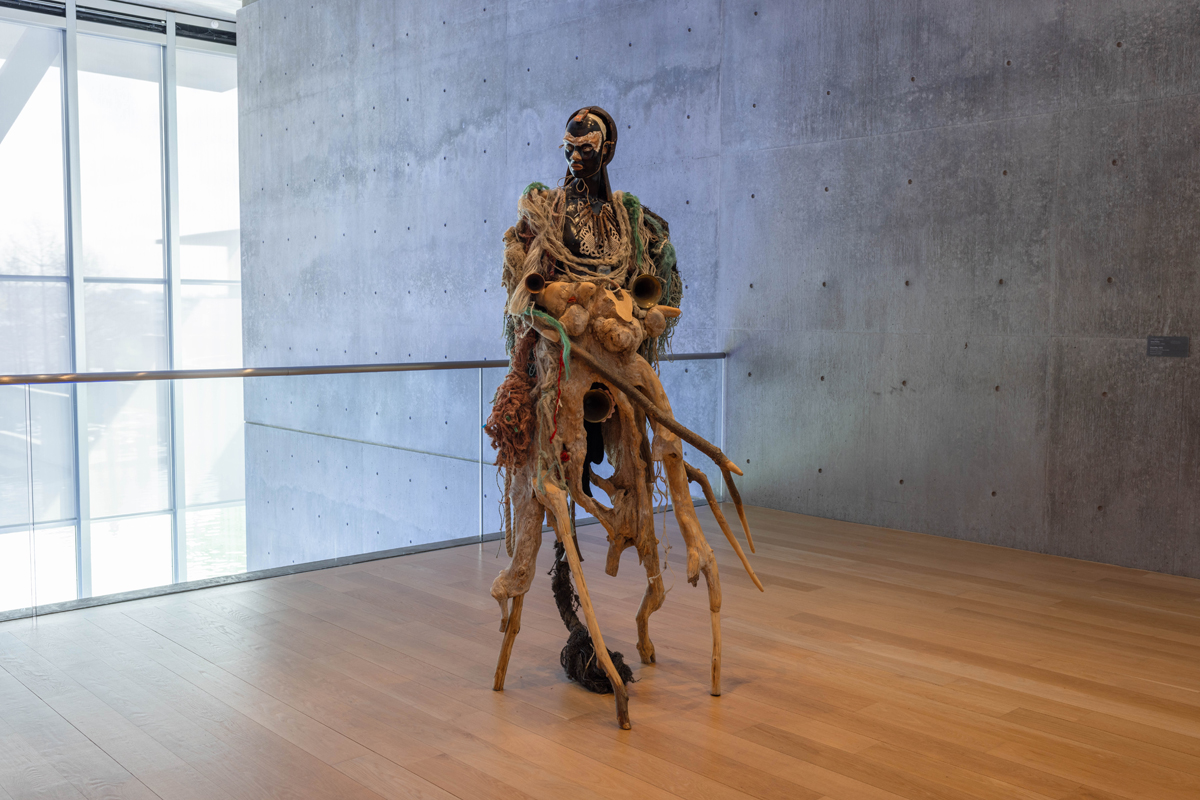 Installation view of a figurative sculpture in a museum space. Curated by Maria Elena Ortiz.