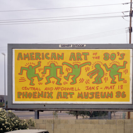 Yellow, red, and turquoise billboard designed by Keith Haring for a 1980s art exhibition at Phoenix Art Museum.