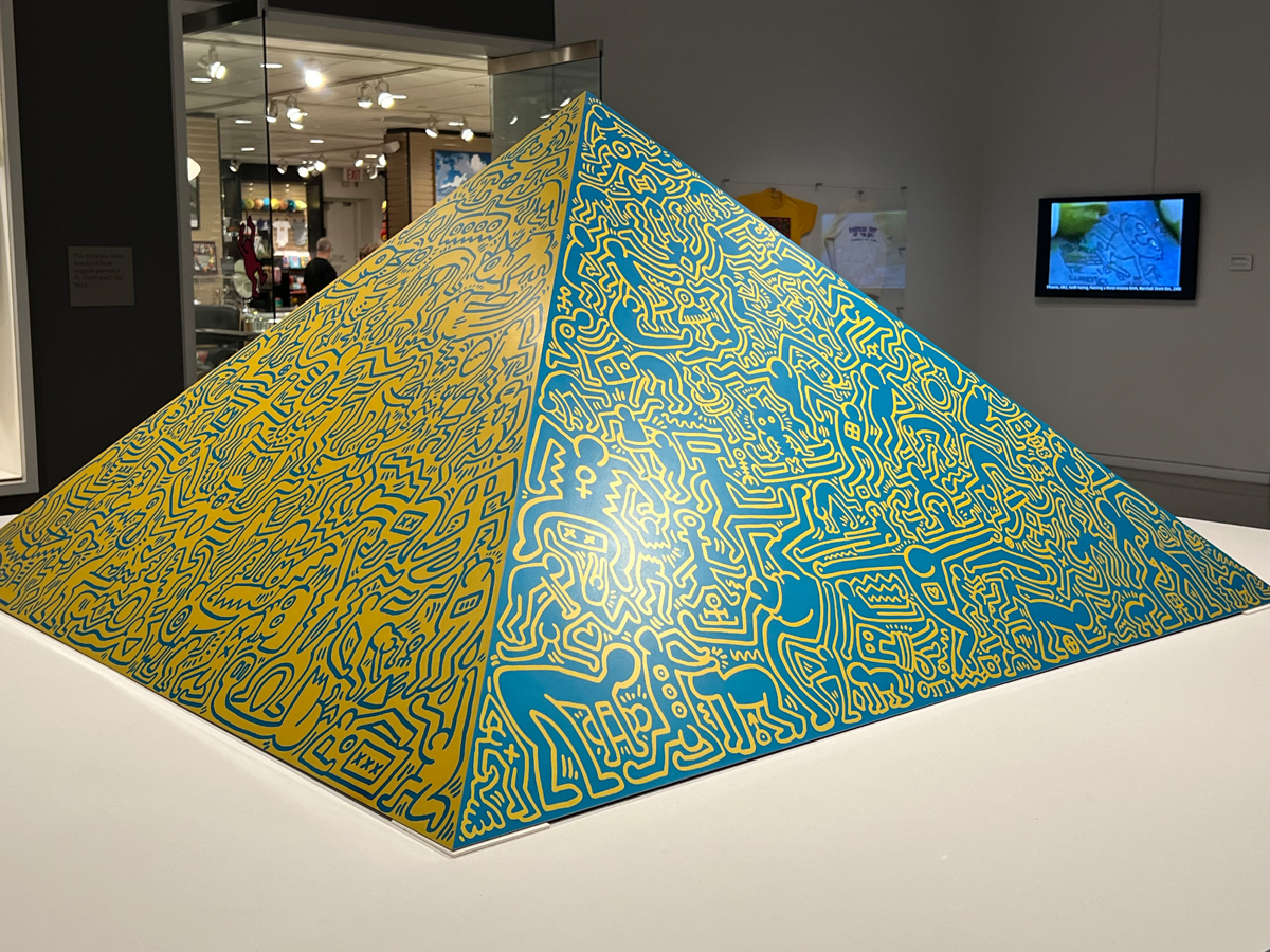 Yellow-and-green pyramid form covered in squiggly doodles by Keith Haring at Phoenix Art Museum.