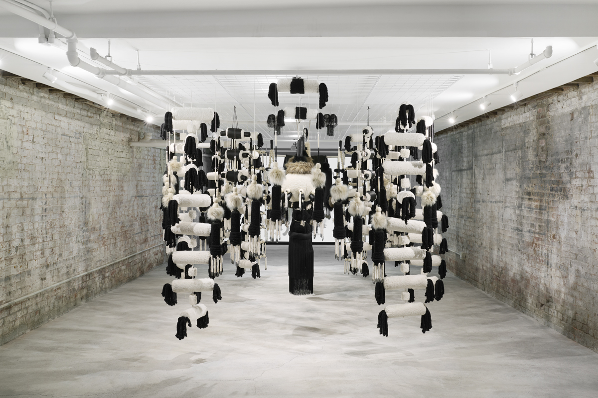 Suspended art installation by Eric-Paul Riege blending materials deemed "authentic" and "inauthentic" in Native craft.