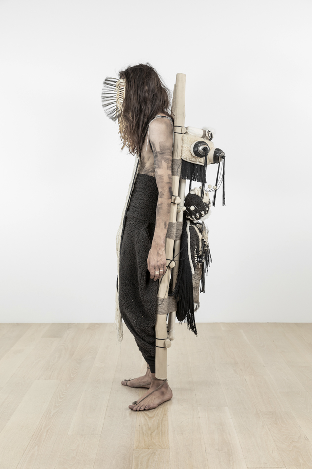 Artist Eric-Paul Riege wears sculptural regalia.