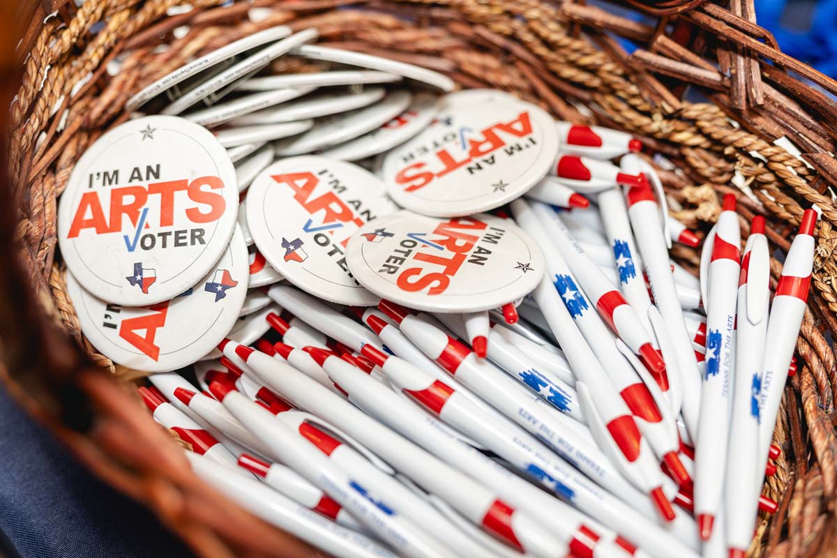 Basket filled with Texans for the Arts pens and buttons that read 