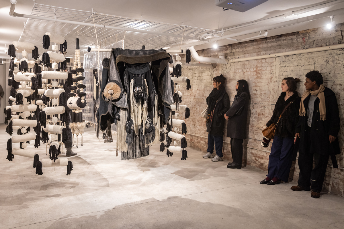 Visitors to Canal Projects take in Eric-Paul Riege's suspended installation iZiiT [3].