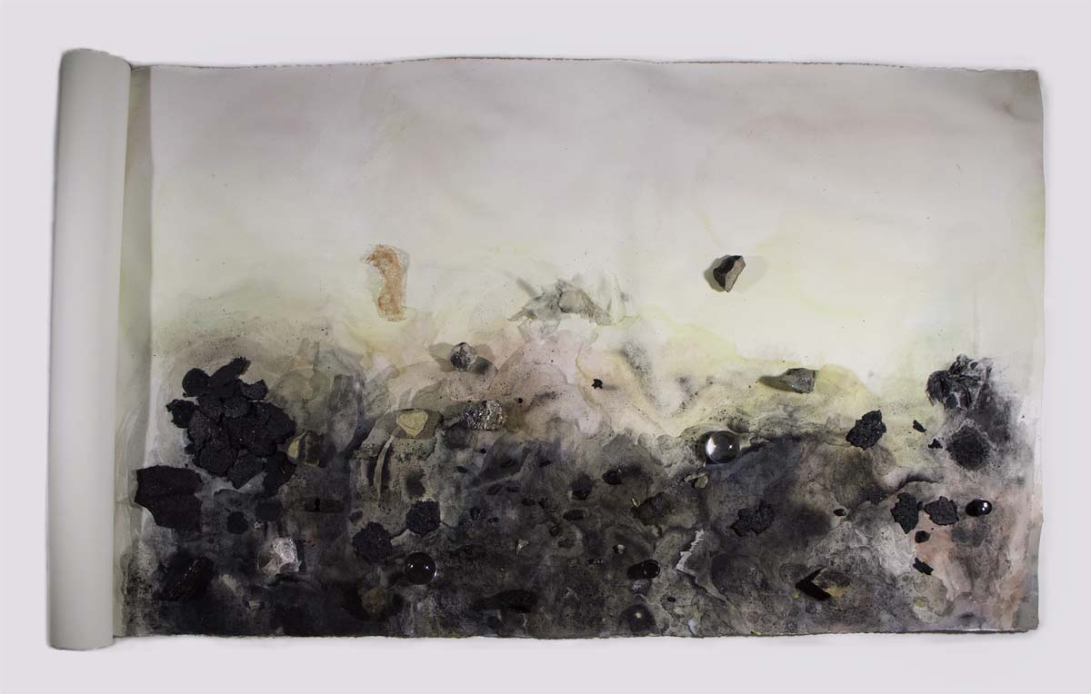 Abstract composition made by Jess Lanham, of watercolor, charred wood, ash, found objects