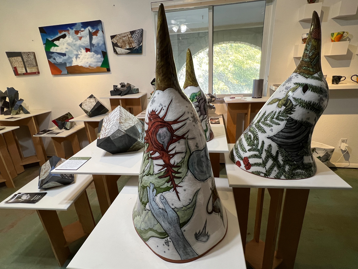 Ceramic artworks and paintings by Farraday Newsome and Jeff Reich, in a display zone of their studio.