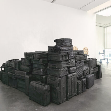 A pile of sculpturally altered suitcases by Denver artist Sammy Lee.