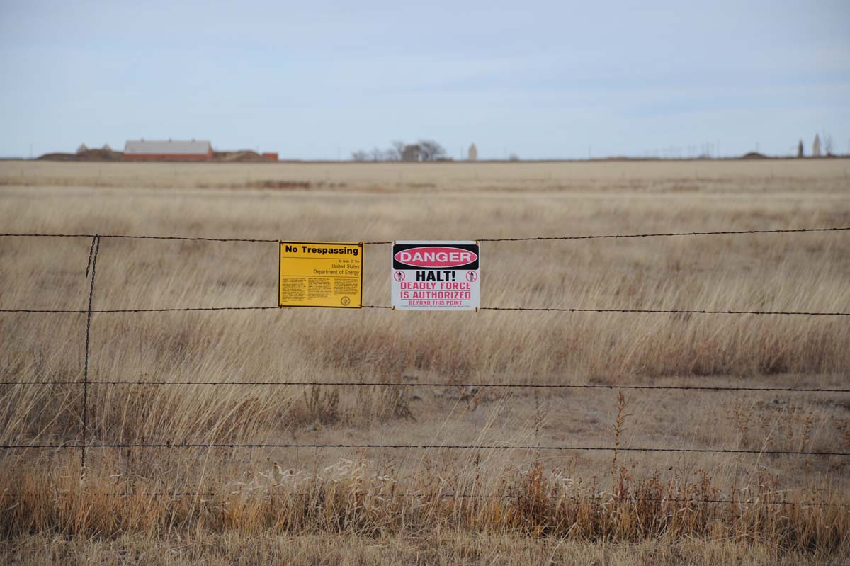 Warning signs posted on barbed wire fences outside of the Pantex plant in Amarillo, Texas.