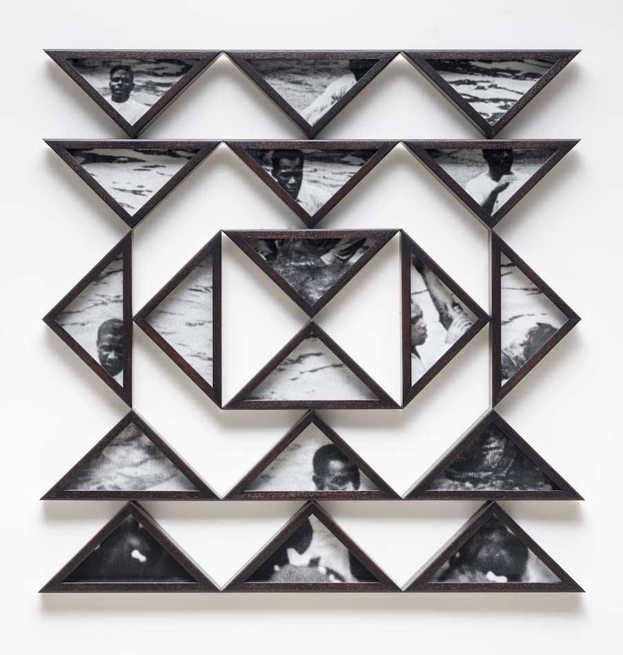 Black and white photo prints in an arrangement of triangular frames.
