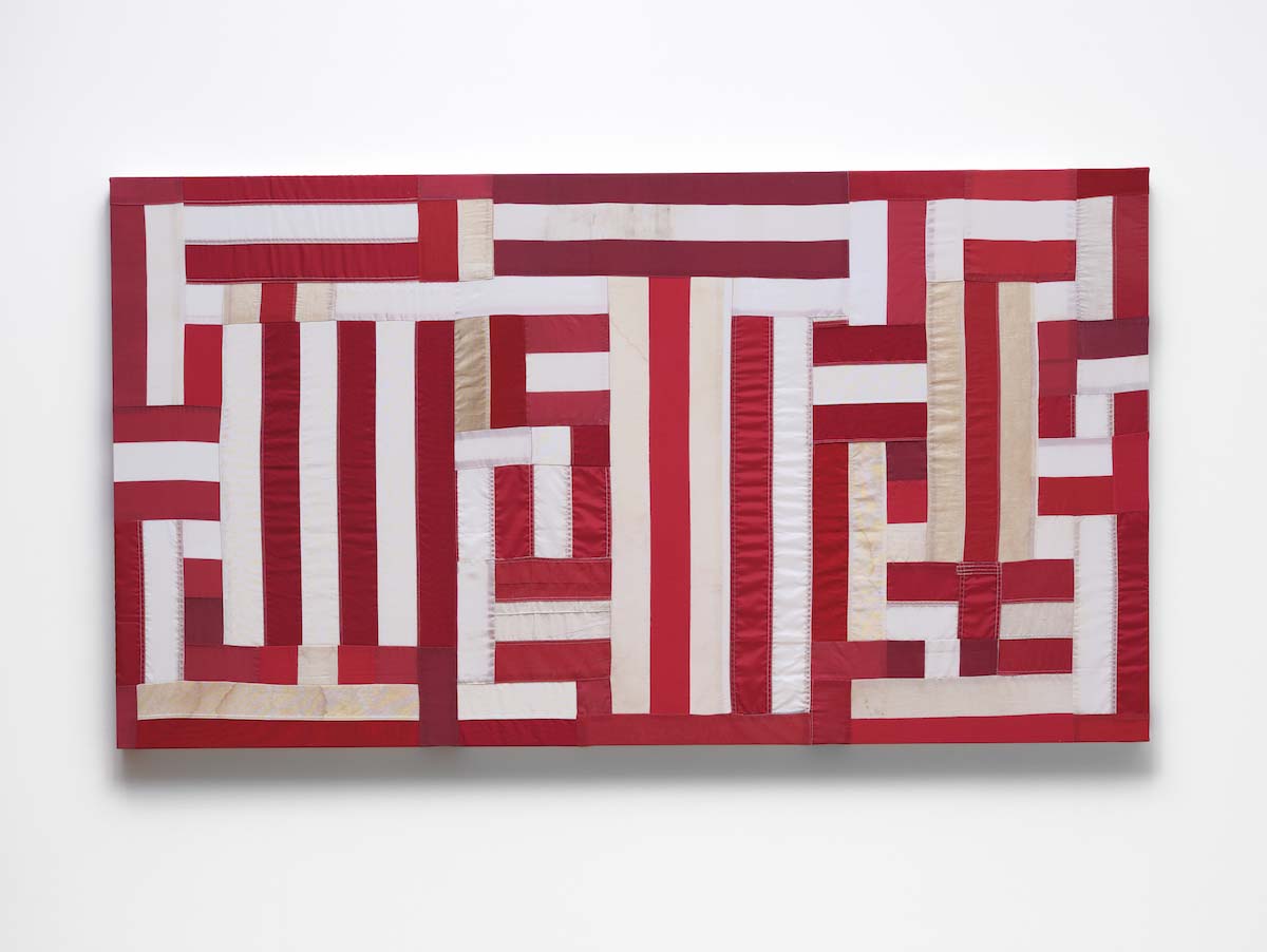 The word Justice spelled using the red and white stripes from a U.S. flag.