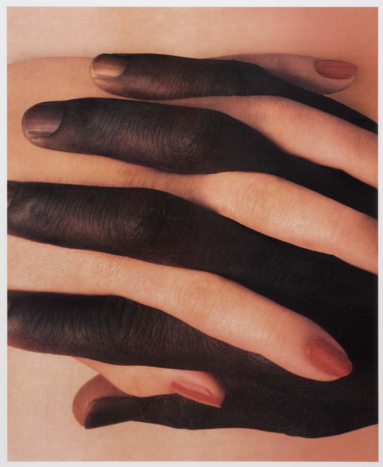 Racially Black and white hands intertwined.