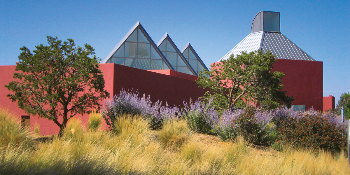 Exterior of Santa Fe Art Institute in midtown Santa Fe. Its vivid red color and Platonic solids are courtesy of architect Ricardo Legorreta.