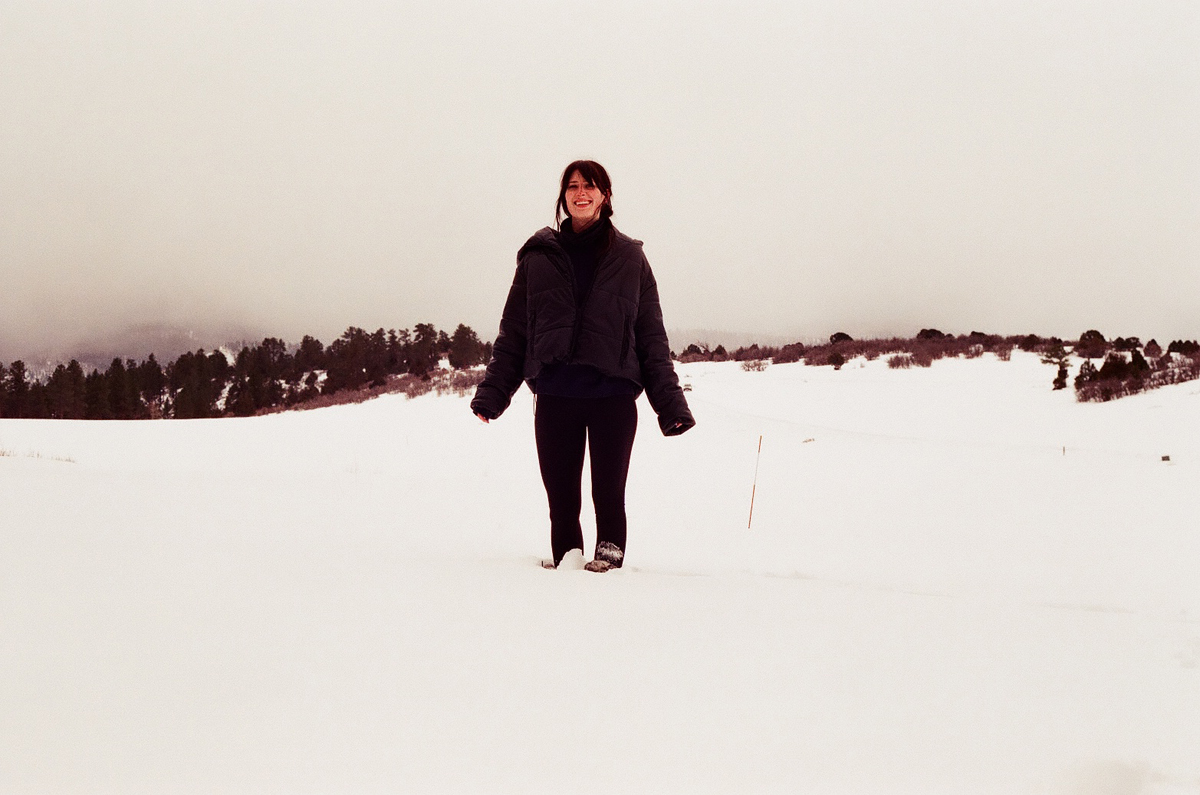 Artist Grace Kennison standing in a snowfield in Ridgway, Colorado.