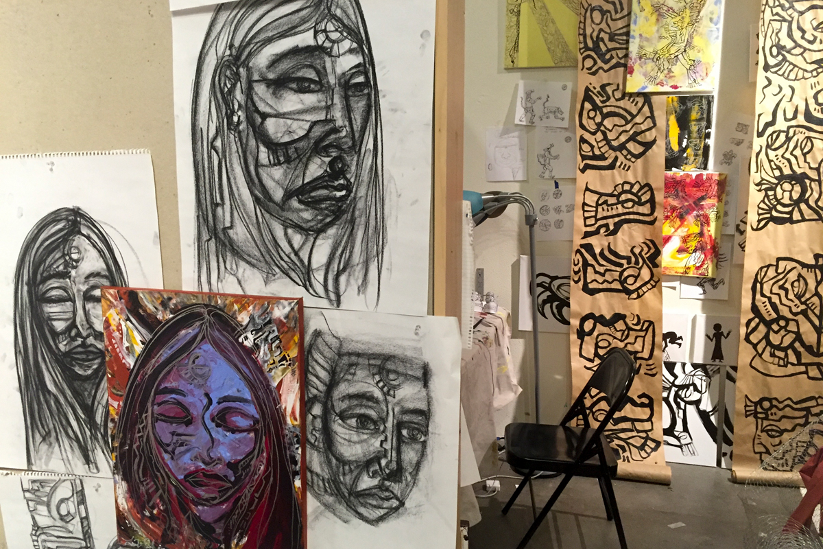 An art studio filled with gestural figurative drawings and paintings at Santa Fe Art Institute.